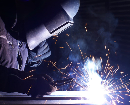 A factory worker performing welding duties