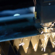 laser cutting machine slices through metal with a focused beam in a fabrication shop