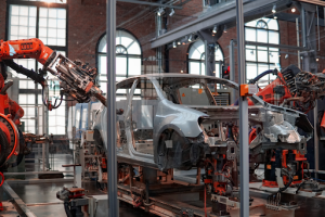 Industrial robots working collaboratively on a car assembly line in a modern factory setting. 