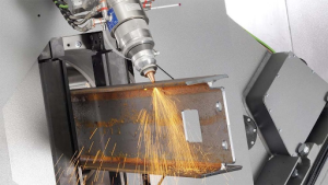 A laser-cutting machine produces sparks as it slices through metal, showcasing industrial precision and power. 