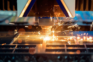 Sparks fly from a machine as it cuts through metal