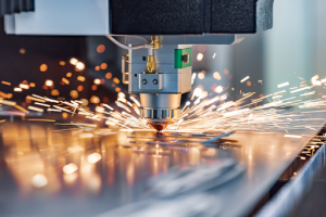 A laser-cutting machine produces sparks as it slices through metal, showcasing industrial precision and power. 