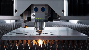 A laser cutting machine slices metal in a workshop