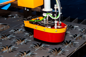 A laser cutting machine in operation, slicing large metal pieces into smaller sections. 