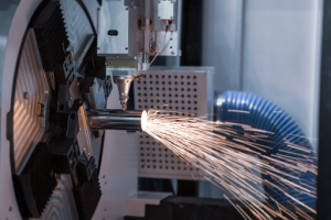  A laser machine is actively cutting metal, generating a shower of sparks in the process. 