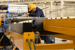  factory worker operates machinery in a production environment. 