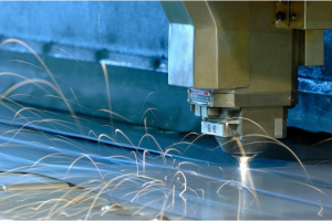 A metal cutting machine produces sparks as it slices through metal, showcasing industrial precision