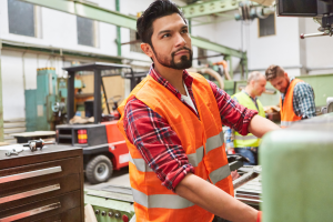 metal worker operates a machine 