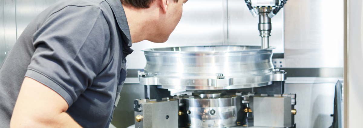 Worker operates a cnc machine