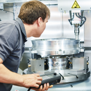 Worker operates a cnc machine