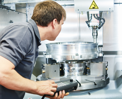 Worker operates a cnc machine