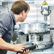 Worker operates a cnc machine