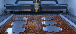  machine cuts a metal sheet, producing sparks