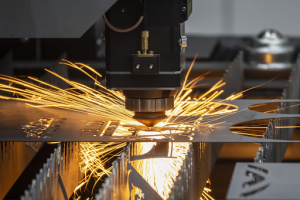 A metal-cutting machine produces sparks as it slices through metal