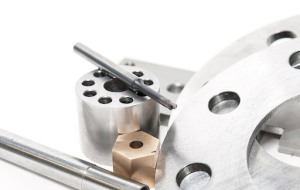 A collection of various metal parts and tools arranged on a white surface.