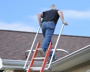 ladder stand-off used by person while climbing a roof