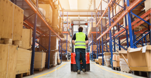 A worker passing through warehouse