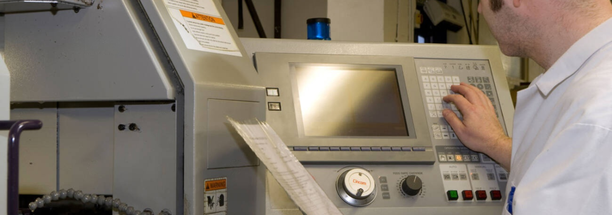 A worker operating CNC Lathe machine