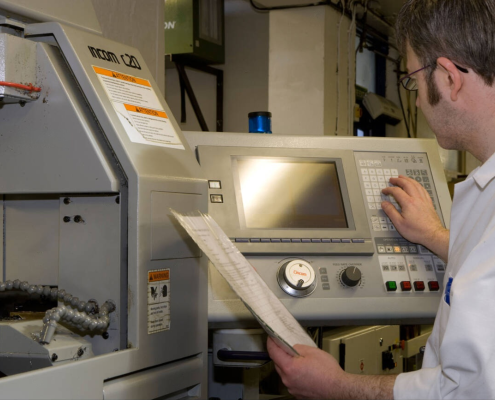 A worker operating CNC Lathe machine