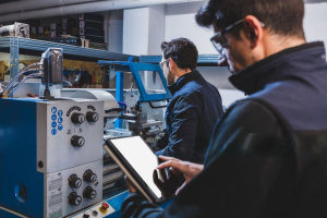 2 workers operating CNC machine