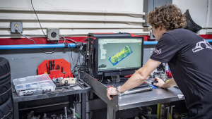 worker using CNC machine programming software
